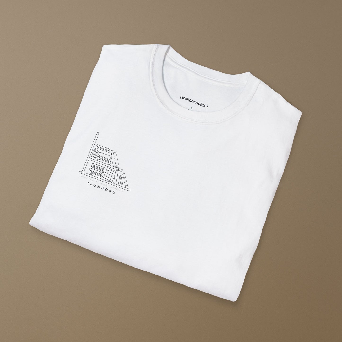 Minimalist unisex folded t-shirt with the word “Tsundoku” in white cotton