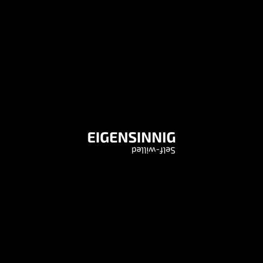 Enlarged design of minimalist unisex t-shirt with “Eigensinnig” in black.