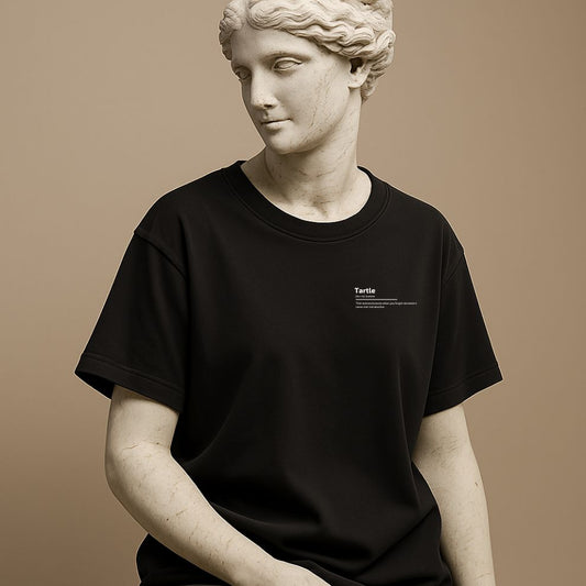 Unisex minimalist t-shirt with the word “Tartle” printed on cotton black fabric on the statue