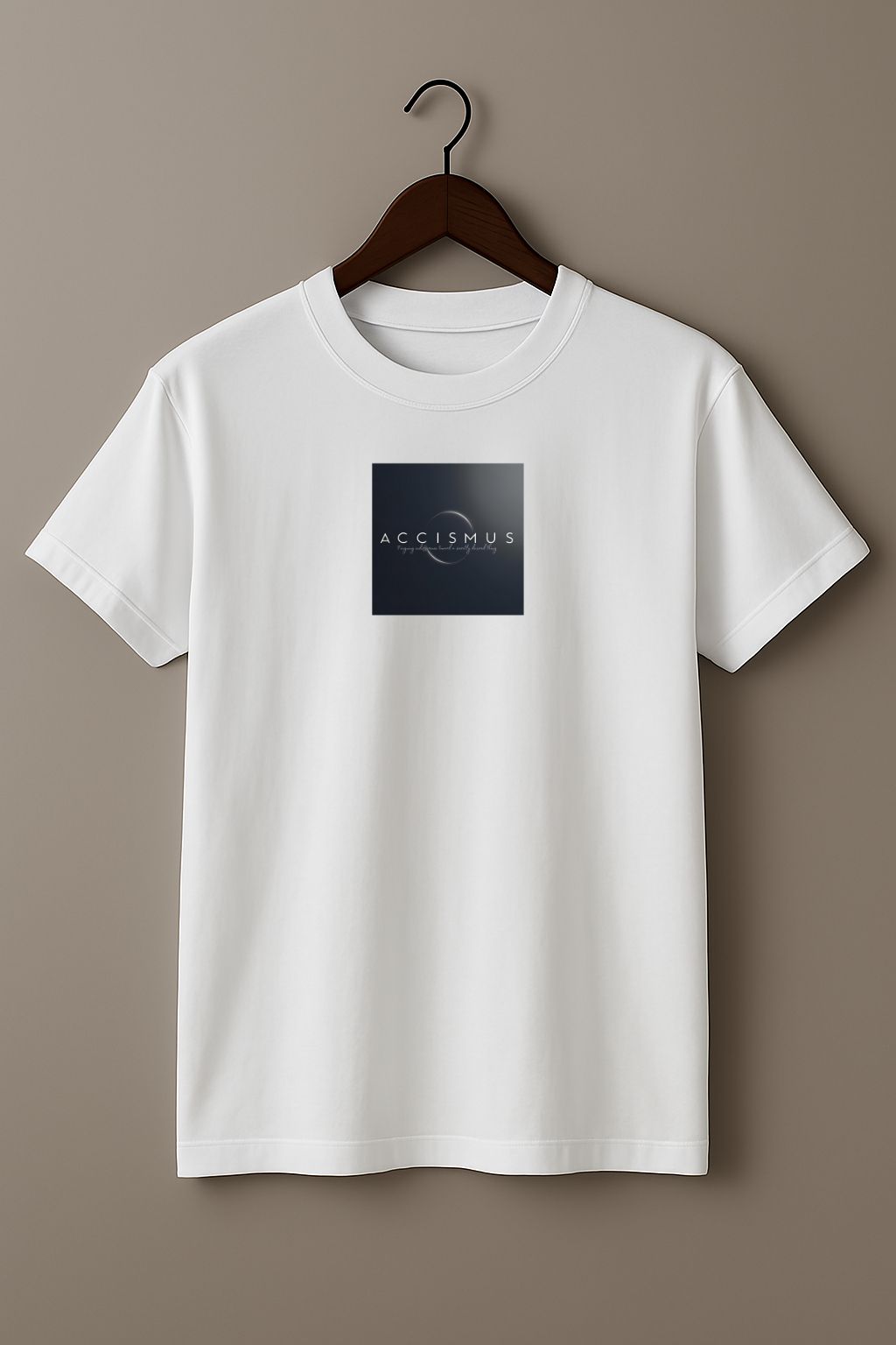 White t-shirt with a design of the word “Accismus” and definition “Feigning indifference toward a secretly desired thing” on a hanger against a plain background