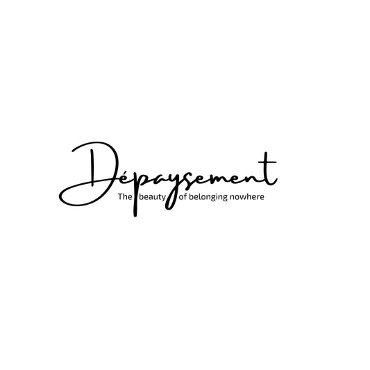 The French word Dépaysement printed in elegant typography and text "The beauty of belonging nowhere" on a white background. Enlarged design for a minimalist T-shirt