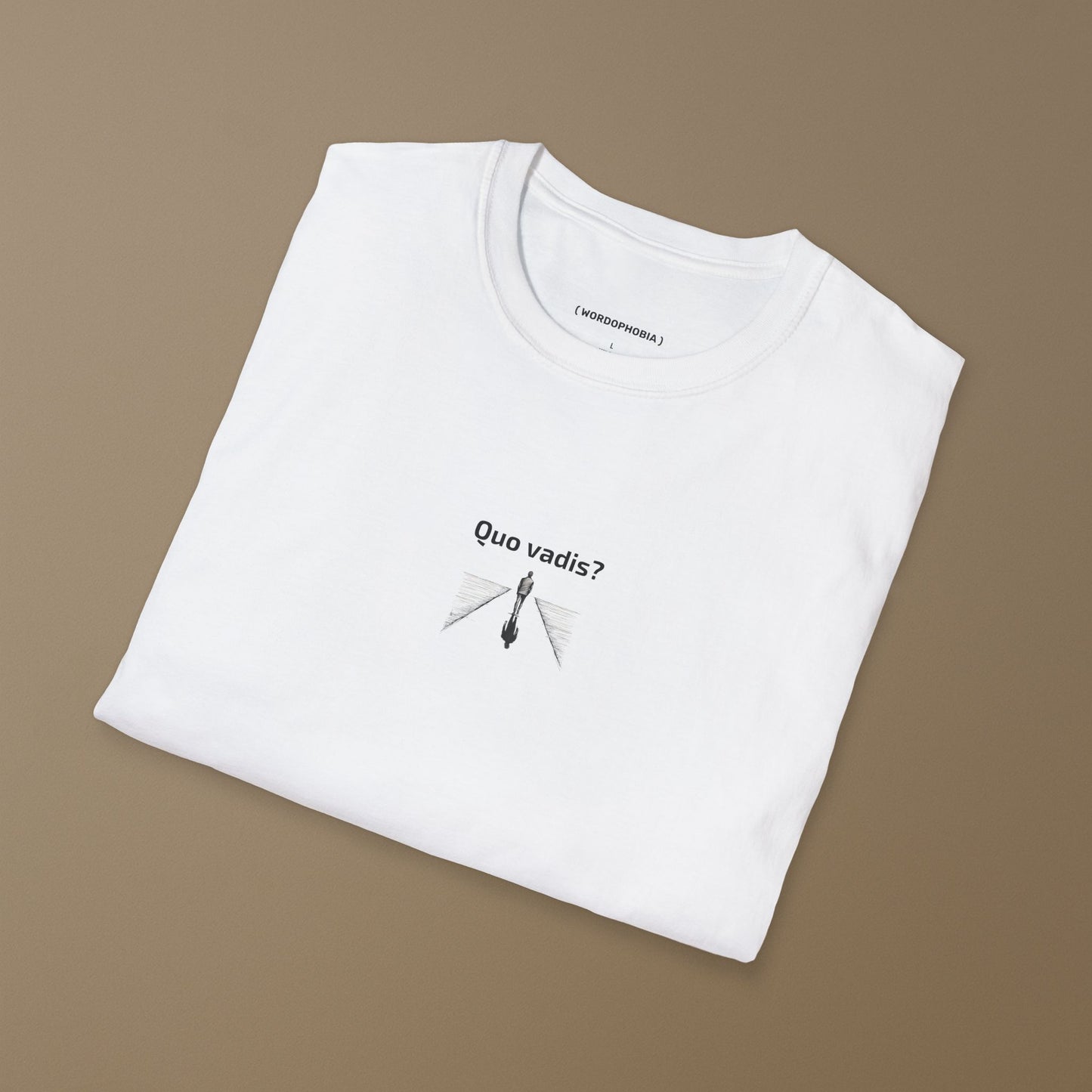 Folded white t-shirt with a black and white illustration of a person standing on a path with 'Quo vadis?' text above on a brown background