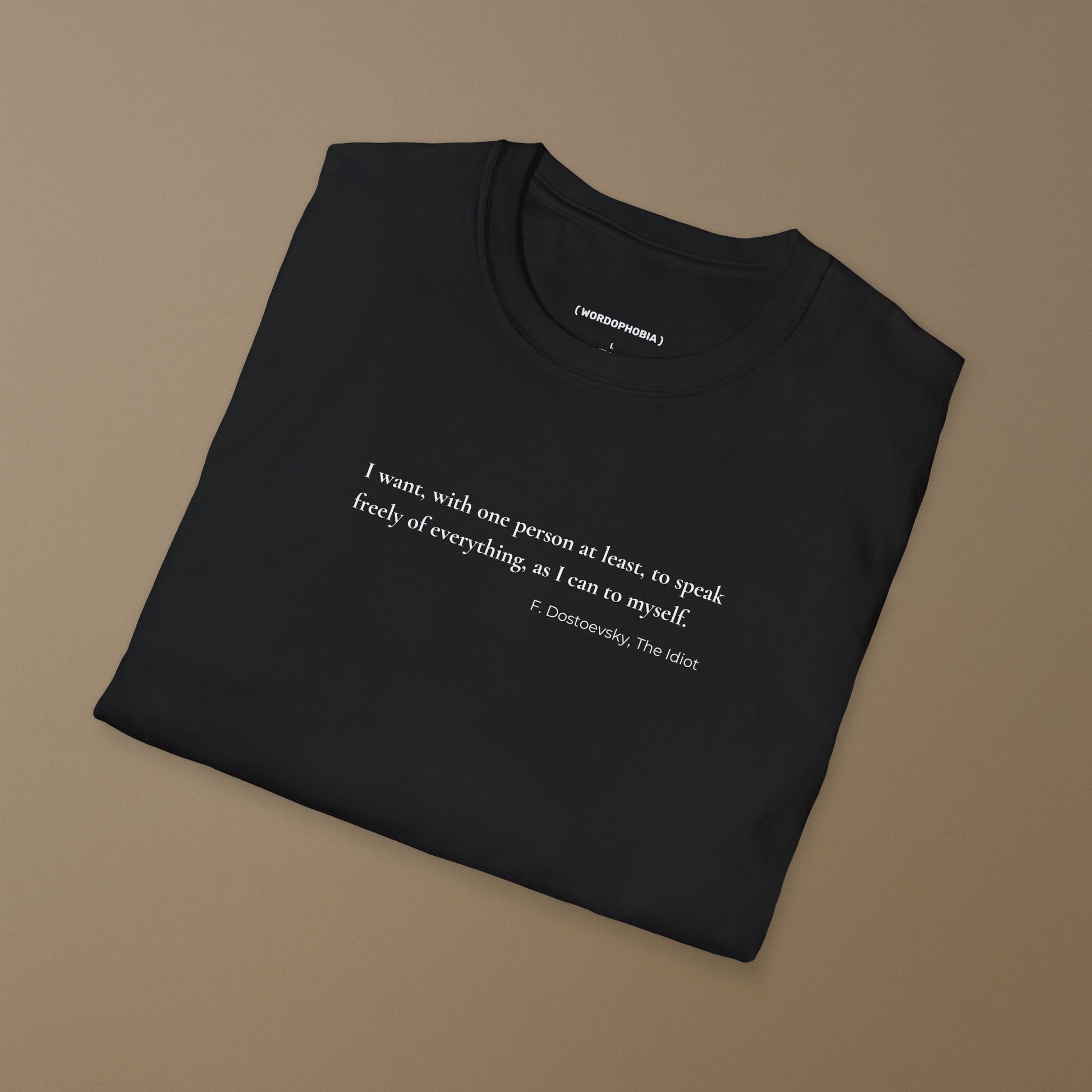 Folded minimalist black t-shirt with Dostoevsky-inspired quote in clean text design. I want, with one person at least, to speak freely of everything as I can to myself. F. Dostoevsky, The Idiot