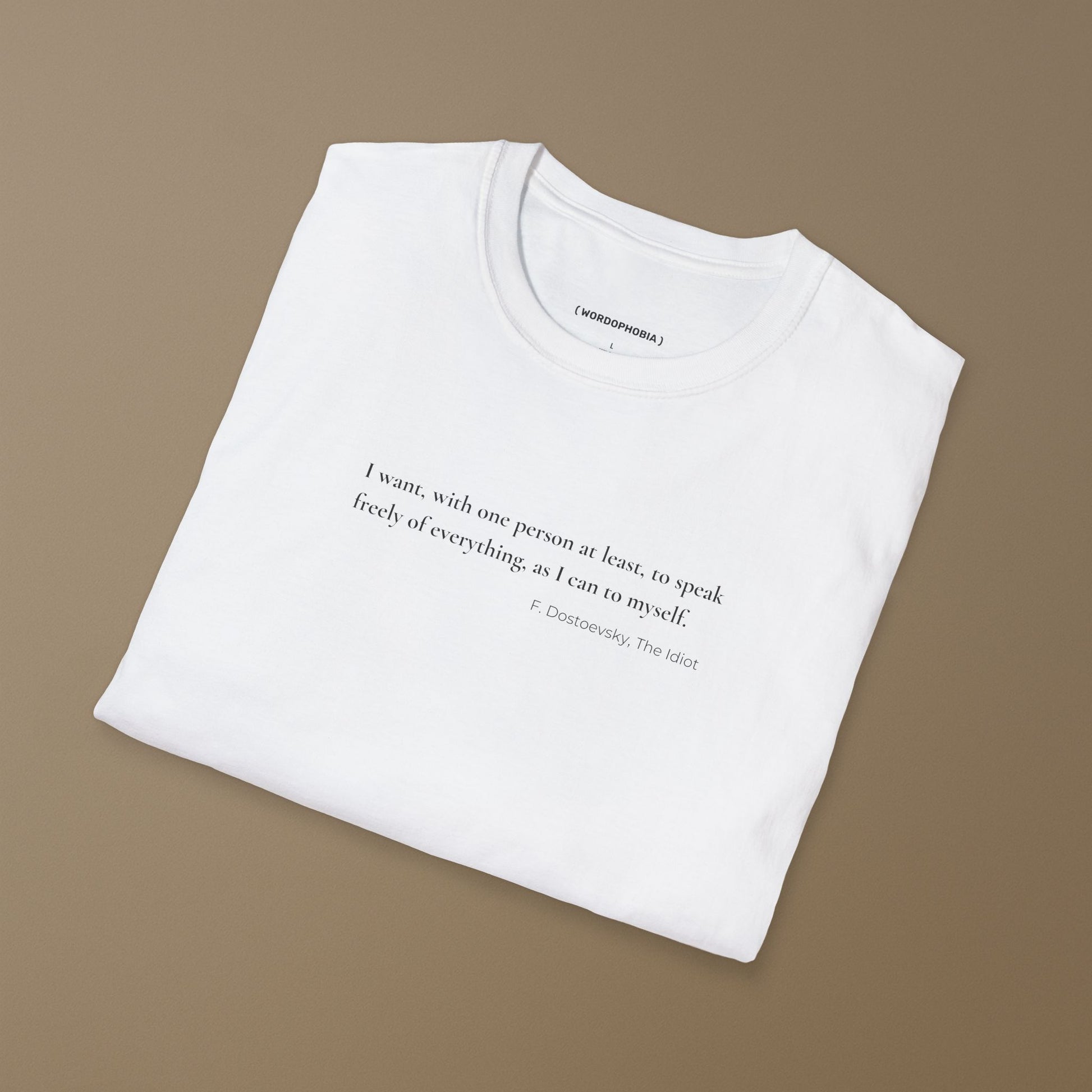 Folded minimalist white t-shirt with Dostoevsky-inspired quote in clean text design. I want, with one person at least, to speak freely of everything as I can to myself. F. Dostoevsky, The Idiot