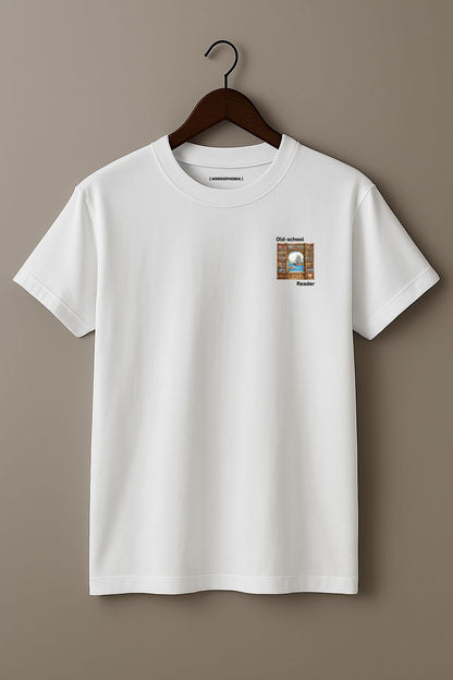 Mock up of white t-shirt with a small graphic and text "Old-school reader" on a wooden hanger on a beige background