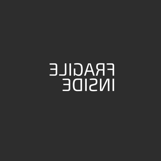 Enlarged design of minimalist t-shirt with phrase “Fragile Inside” in black cotton