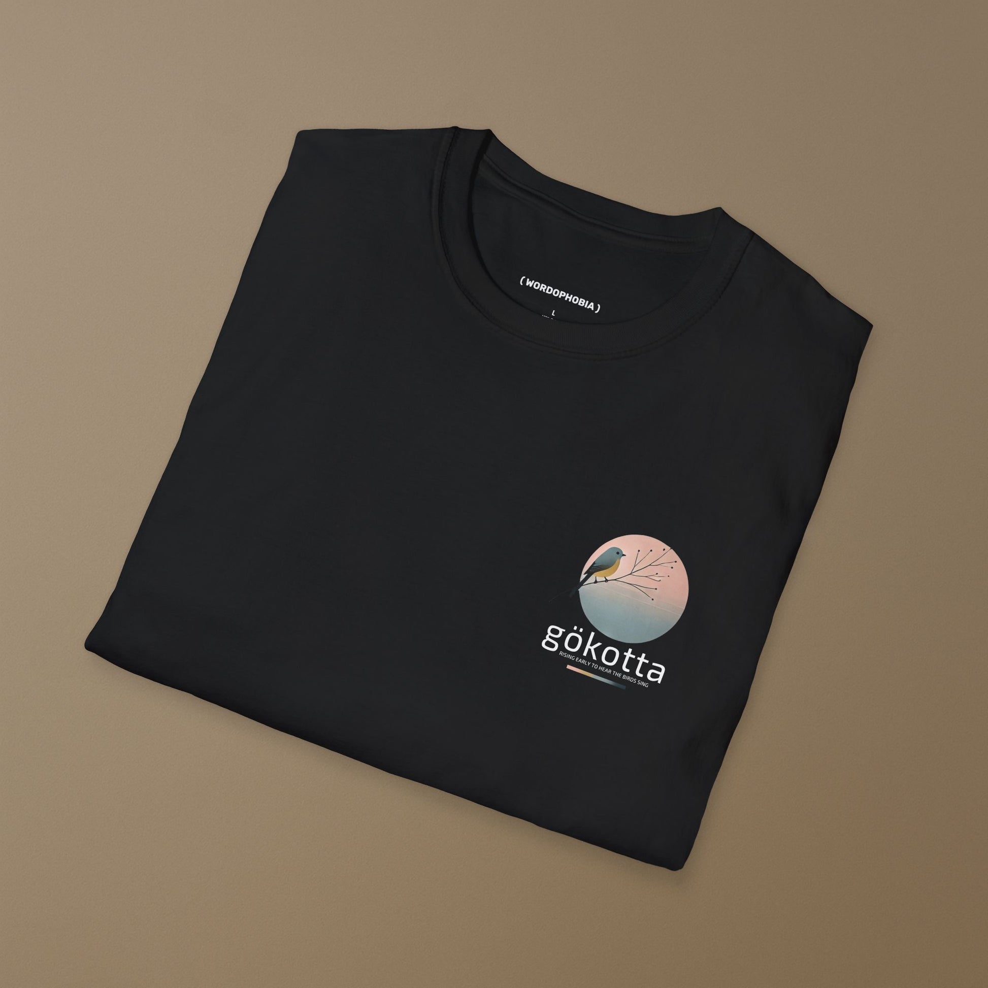 Minimalist folded t-shirt with Swedish word Gökotta in black cotton 