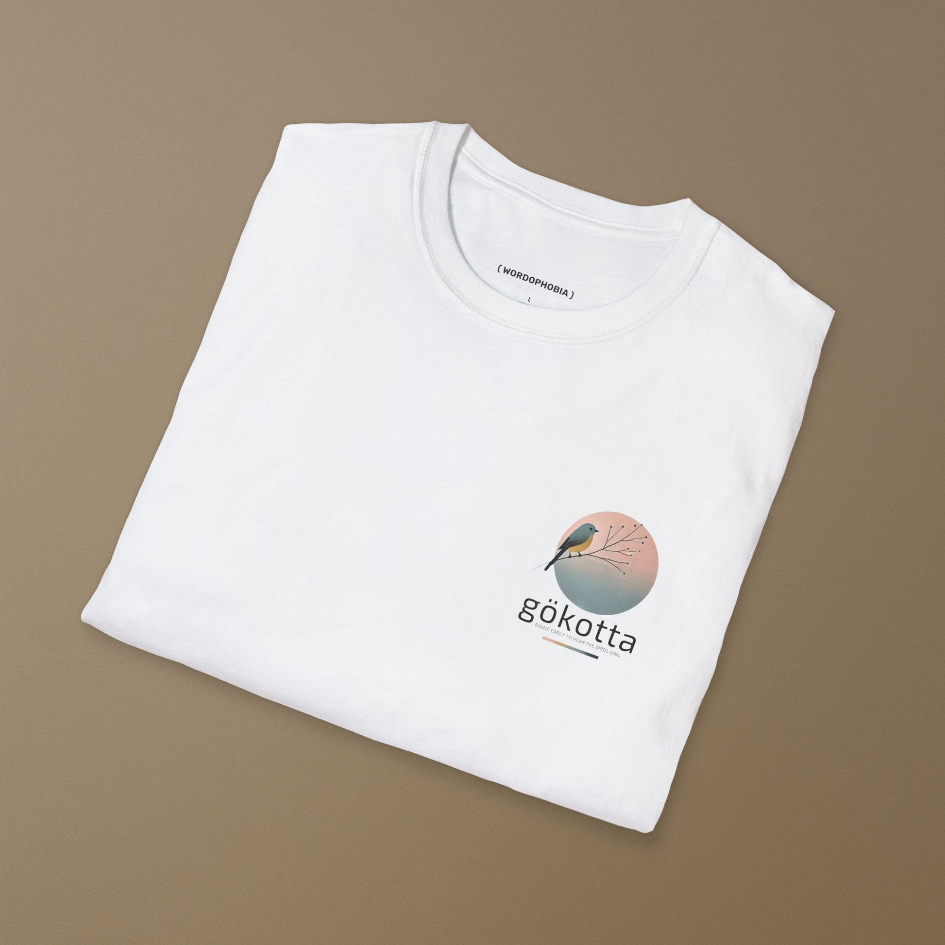 Minimalist folded t-shirt with Swedish word Gökotta in white cotton 