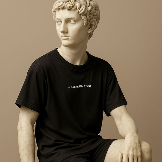 Unisex minimalist t-shirt with the phrase “In Books We Trust” in black cotton on the statue