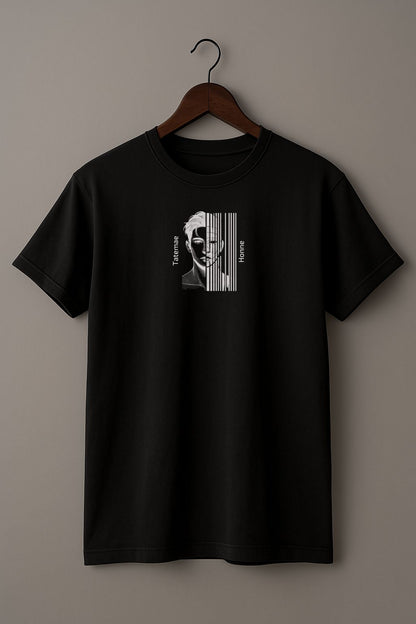 Black t-shirt with a black and white illustration of a person with 'Tatemae' and 'Honne' text on a hanger against a beige background