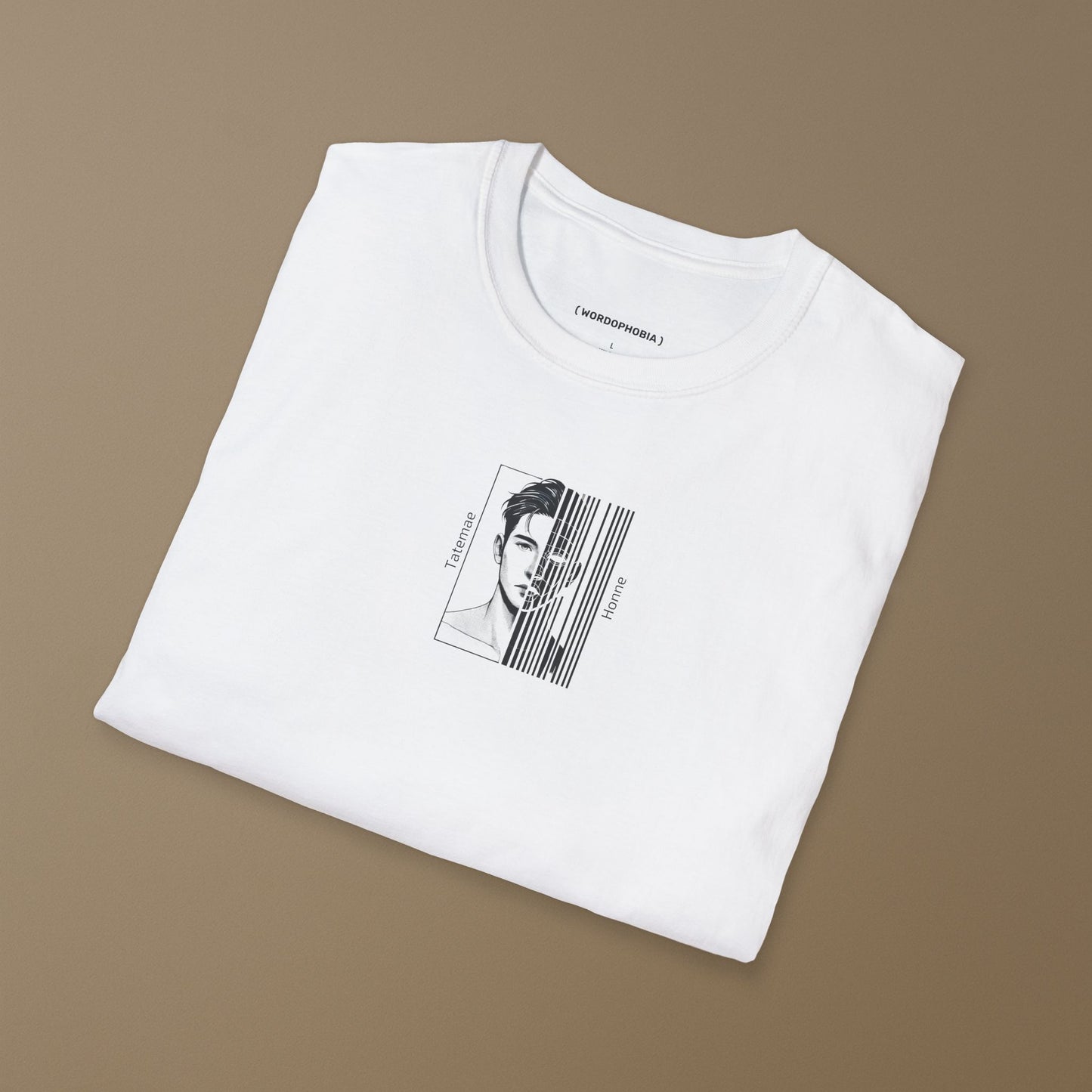 Folded white T-shirt with a black and white illustration of a person with 'Tatemae' and 'Honne' text on a beige background