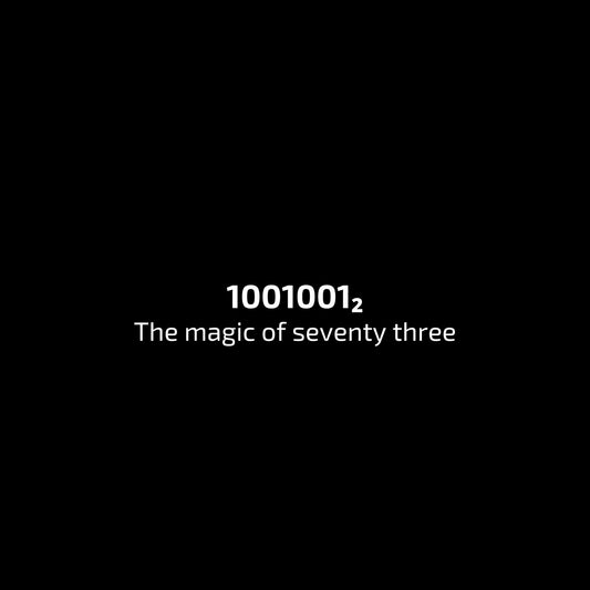 Binary code '1001001_2' displayed on a black background with text 'The magic of seventy three'. enlarged design for a minimalist t-shirt