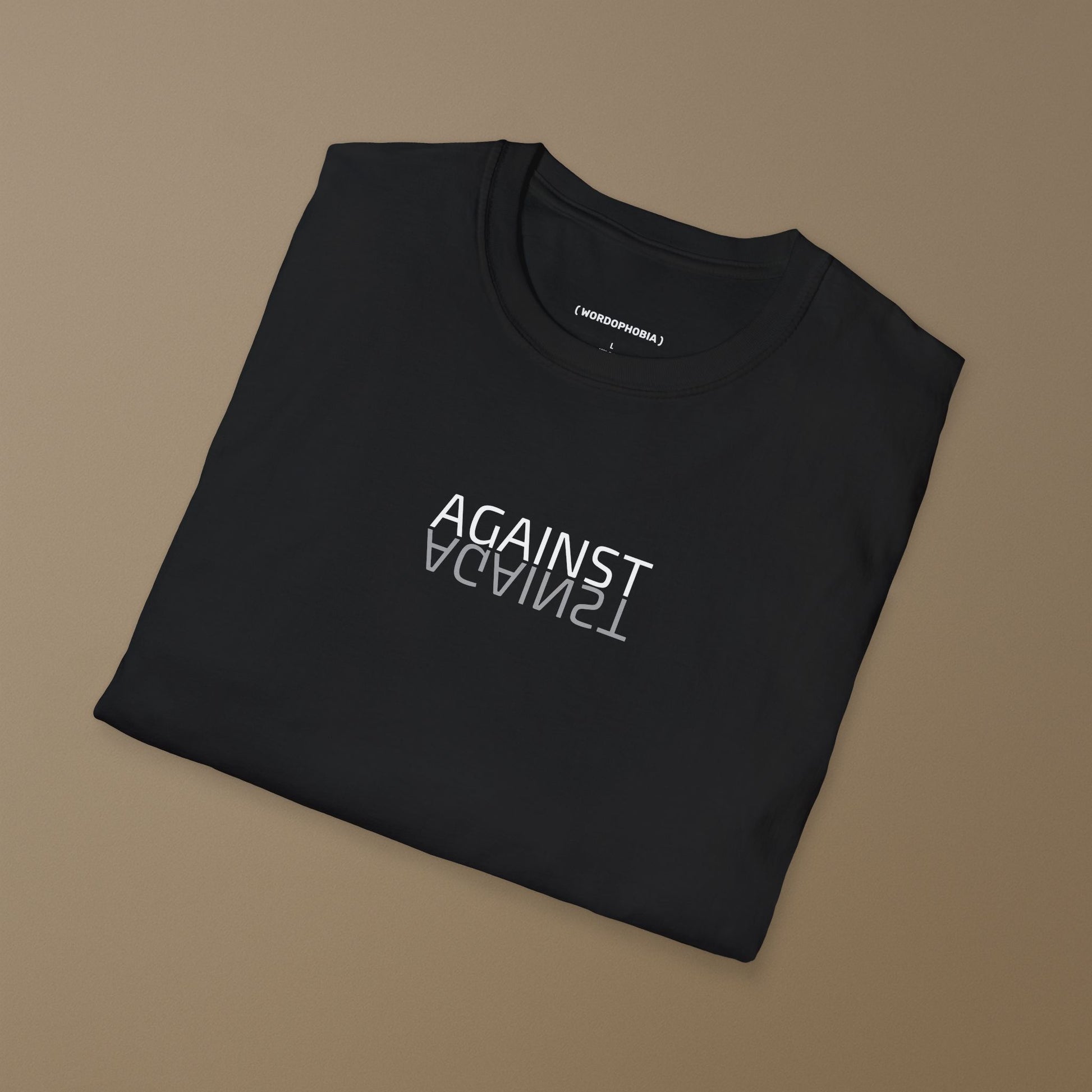 Folded black t-shirt with 'AGAINST' text on a brown background