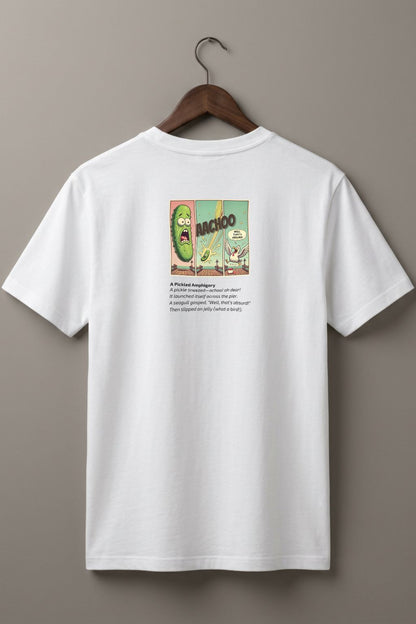 White t-shirt (back side)  with a graphic comic design of a pickle and a poem below on a hanger against a plain wall
