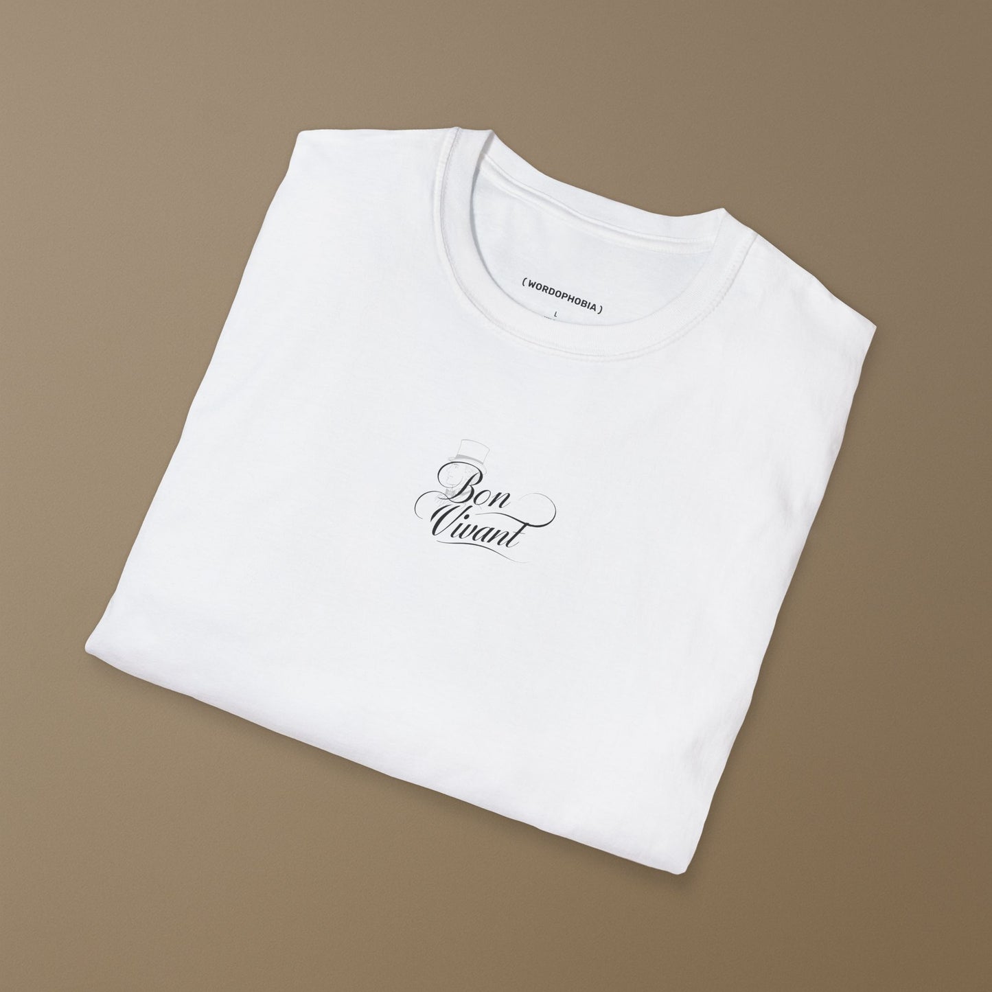 Folded white t-shirt with black design of 'Bon Vivant' with a silhouette of a person wearing a top hat  on a wooden hanger against a beige wall