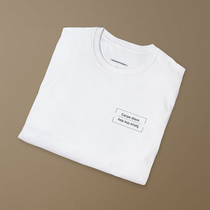 Folded white t-shirt with the Latin phrase “Carpe diem,” meaning “Seize the day,” printed in clean modern typography on a beige background 