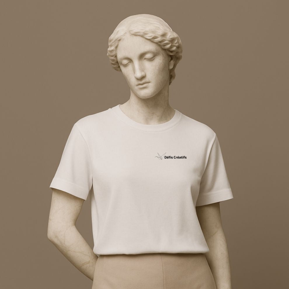 Statue wearing a white t-shirt with a small graphic design and text Defis Creatifs on a brown background