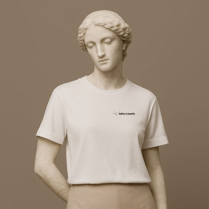 Statue wearing a white t-shirt with a small graphic design and text Defis Creatifs on a brown background