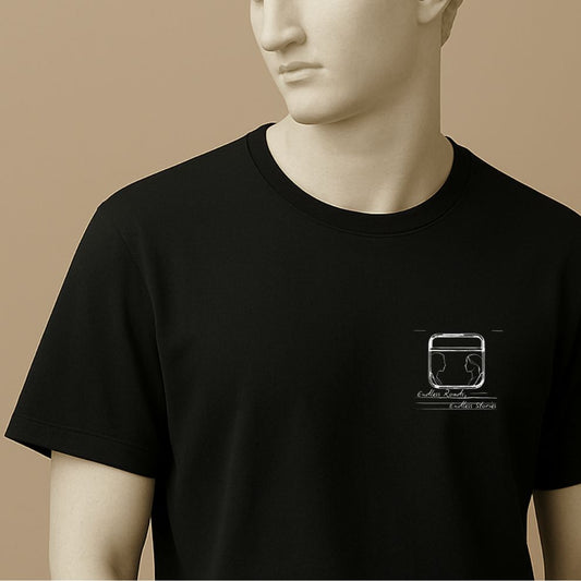 Statue wearing a black t-shirt with a graphic minimalist design of a train window with 2 silhouettes and handwritten text "Endless Roads, Endless Stories" 