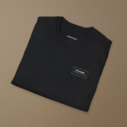 Folded black t-shirt with a small design of  the word 'Fernweh' and tagline 'The longing for distant places' on a beige background