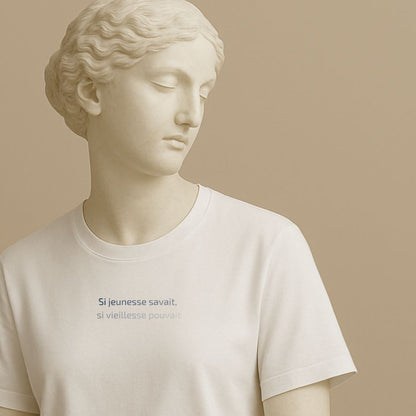 Statue wearing a white t-shirt with the French proverb "Si jeunesse savait, si vieillesse pouvait" in clean typography on a beige background
