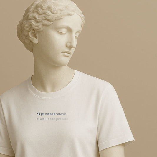 Statue wearing a white t-shirt with the French proverb "Si jeunesse savait, si vieillesse pouvait" in clean typography on a beige background
