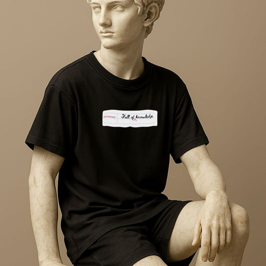 Statue wearing a black t-shirt with the phrase "Full of Dormant Knowledge"  on a beige background