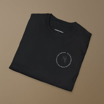 Folded black t-shirt with a graphic of a line drawing of a classical woman's profile with Greek goddess names around her head on a beige background