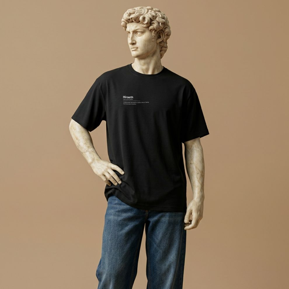 Statue wearing a black t-shirt with graphic design of the word Hiraeth on a beige background