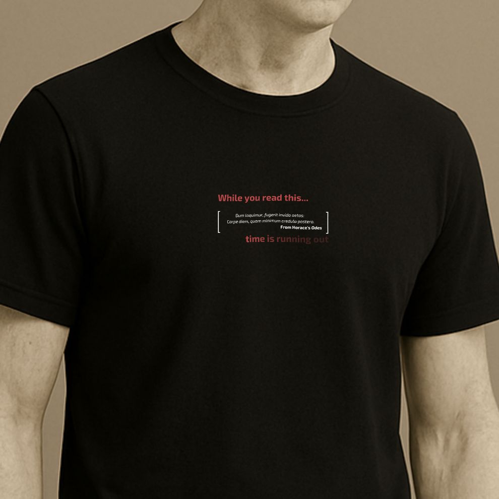 Roman statue wearing a black minimalist t-shirt with the Latin phrase “Dum loquimur, fugerit invida aetas: carpe diem” from Horaceon a beige background