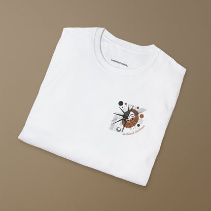 Folded white t-shirt with a graphic design with sun-like symbol and text 'Sol lucet omnibus' (The sun shones for all)  on a beige background