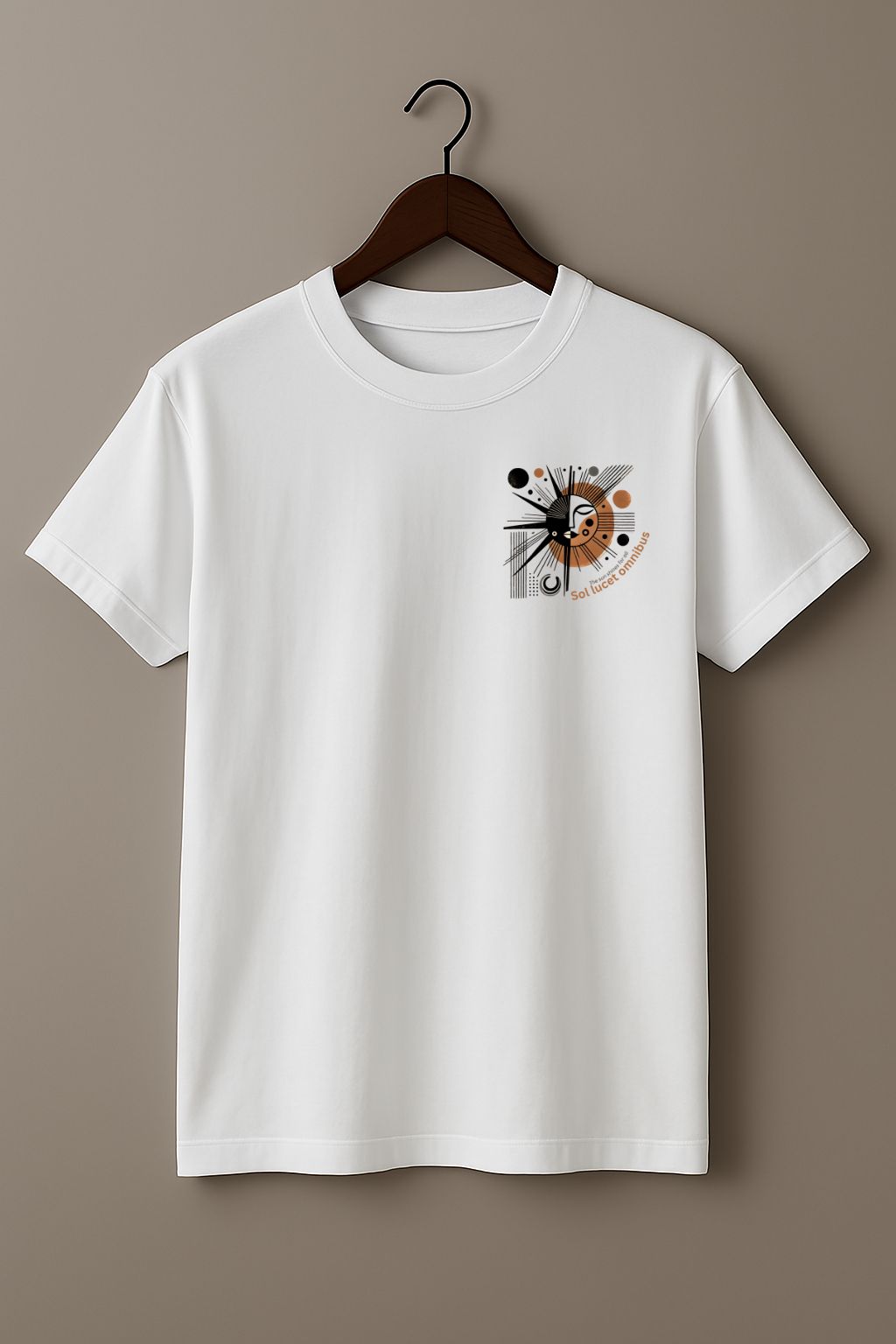 White t-shirt with a graphic design with sun-like symbol and text 'Sol lucet omnibus' (The sun shones for all)  on a hanger against a beige background