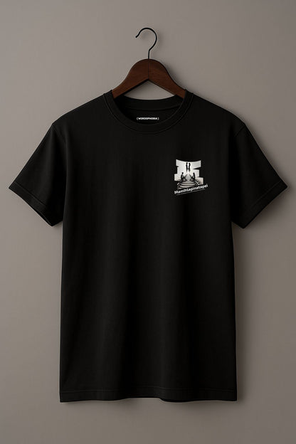 Black t-shirt with a graphic of a silhouette artwork of two people on a railway track with text 'Mamihlapinatapei' below on a wooden hanger against a plain background