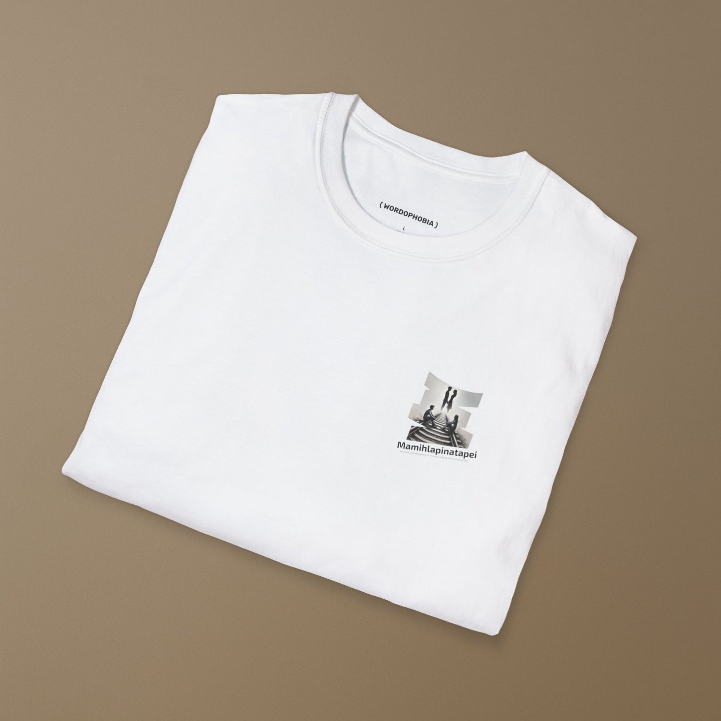 Folded white t-shirt with a graphic of a silhouette artwork of two people on a railway track with text 'Mamihlapinatapei' 