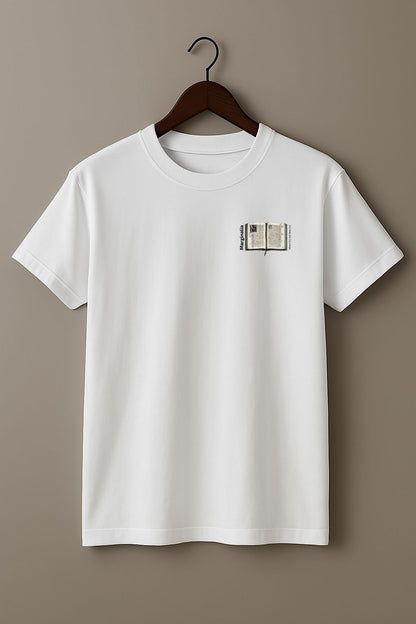 White t-shirt with a small graphic of Enlarged design of open old book with text "Marginalia" and "Where the real ideas live" on a hanger against a beige background