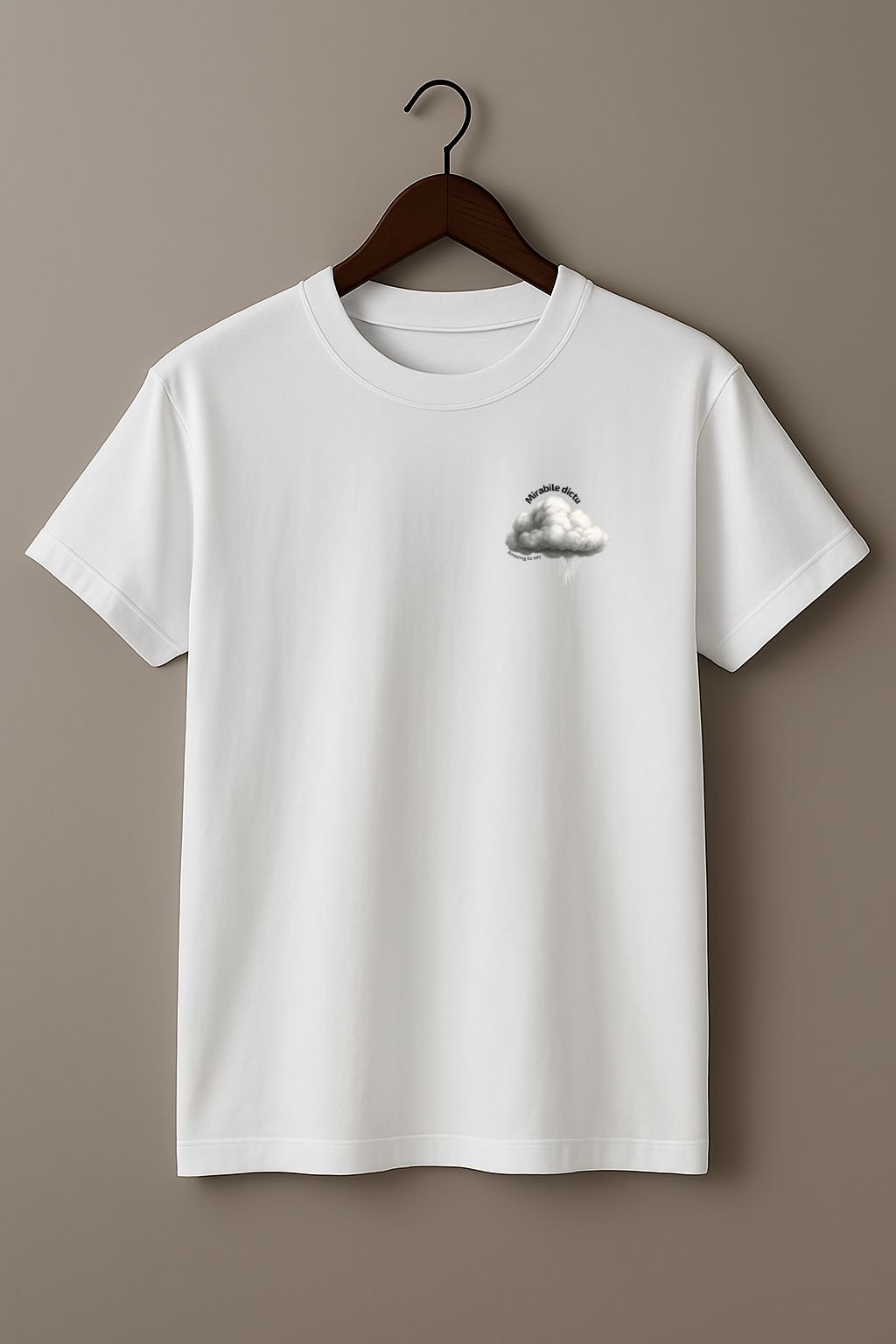 White t-shirt with a white cloud design and 'Mirabile dictu' and 'Amazing to say' text on a wooden hanger against a beige wall