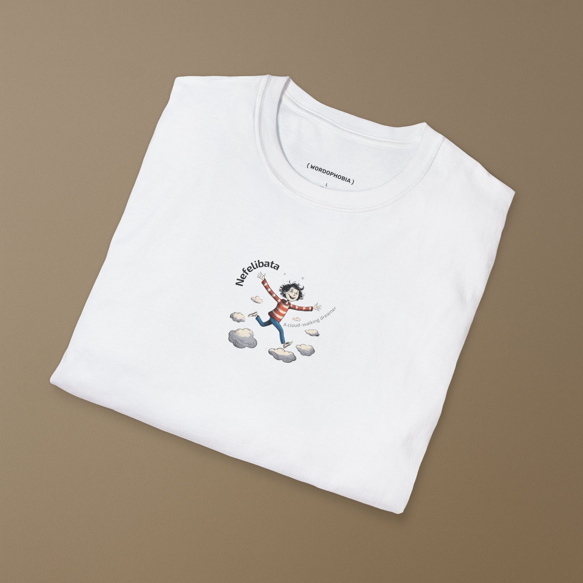 Folded white t-shirt with a graphic design of a  funny child running on clouds with 'Nefelibata' text and phrase "A cloud-walking dreamer" on a beige background