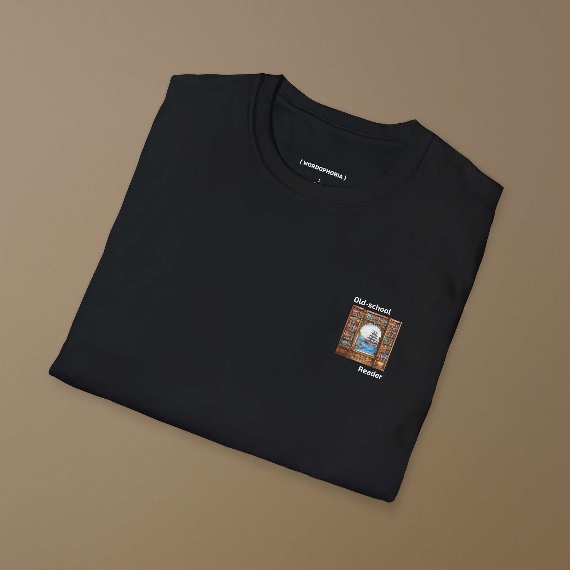 Folded black t-shirt with a small graphic and text "Old-school reader" on a brown background