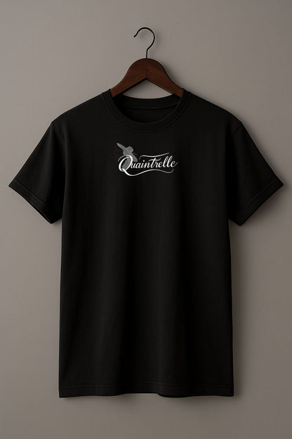 Black t-shirt with a small design of a word Quaintrelle, symbolizing elegant and intentional living, and silhouette of women on a hanger against a beige background