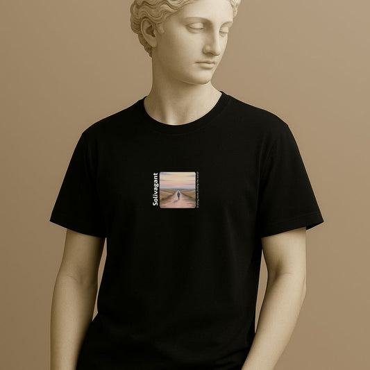 Statue wearing a black t-shirt with design of the word “Solivagant,” text “Drifting alone, finding the world,” and watercolor art of a lone traveler walking between hills on a beige background