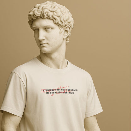 Minimalist white t-shirt with Latin phrase “Ut quisque est doctissimus, ita est modestissimus” in clean typography, wisdom-inspired design on the Roman statue