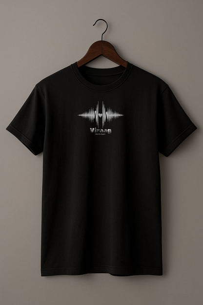 Black t-shirt with a white sound wave design with a heart symbol and 'Viraag' (Hearts Apart) text  on a hanger against a beige background