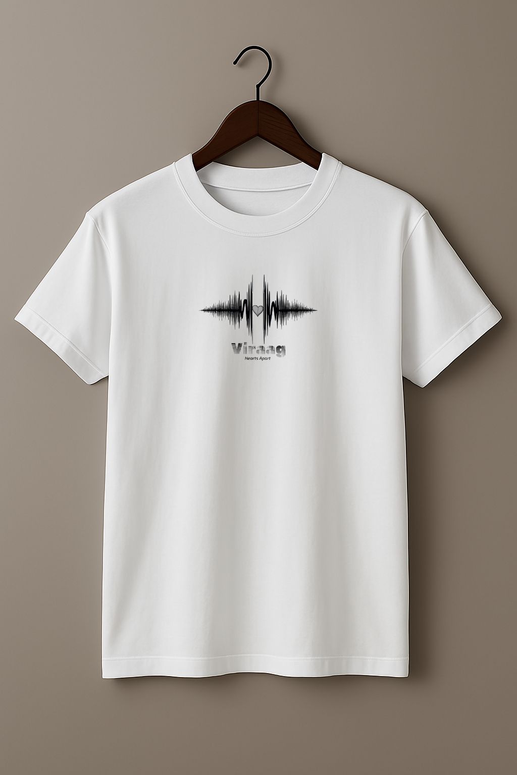 White t-shirt with a black sound wave design with a heart symbol and 'Viraag' (Hearts Apart) text  on a hanger against a beige background
