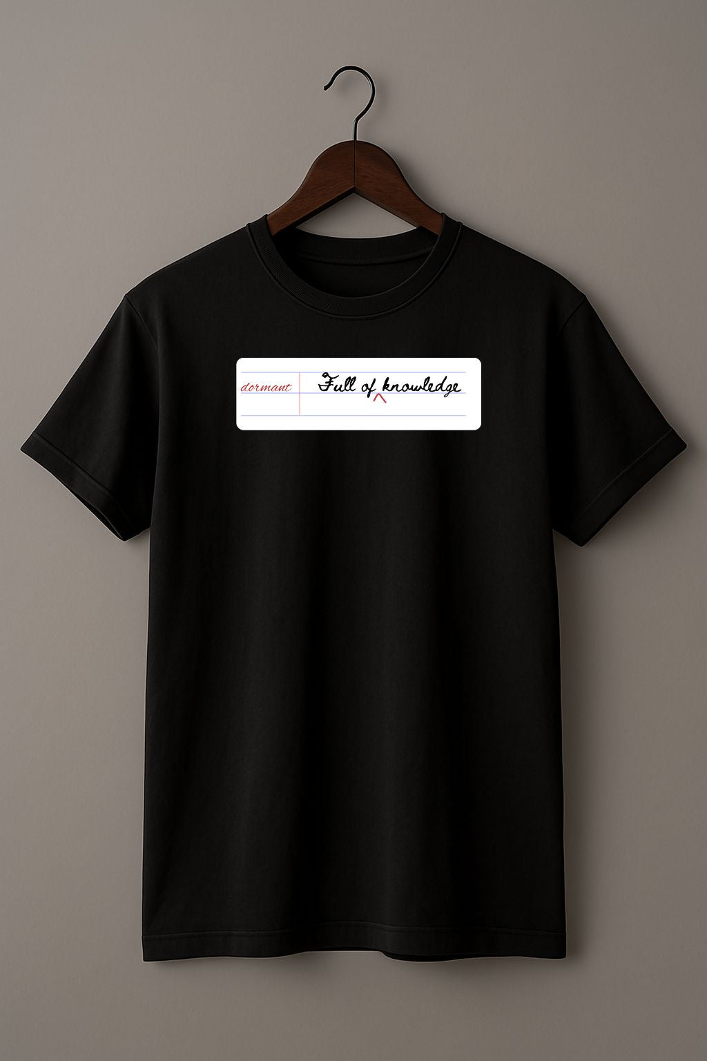 Black t-shirt with a white notebook page with 'dormant'  and 'Full of knowledge' on a hanger against a gray background