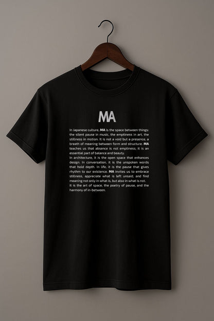Black t-shirt with white text Ma and its concept on a hanger against a beige background