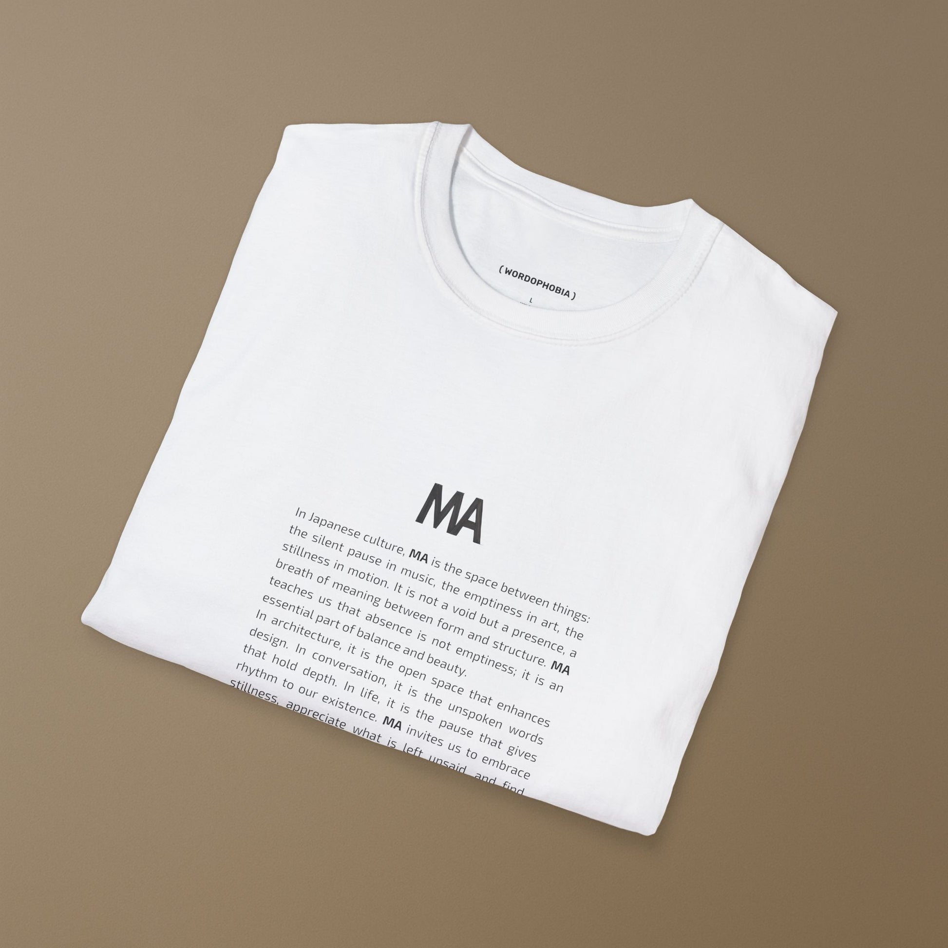 White t-shirt with black text Ma and its concept on a beige background