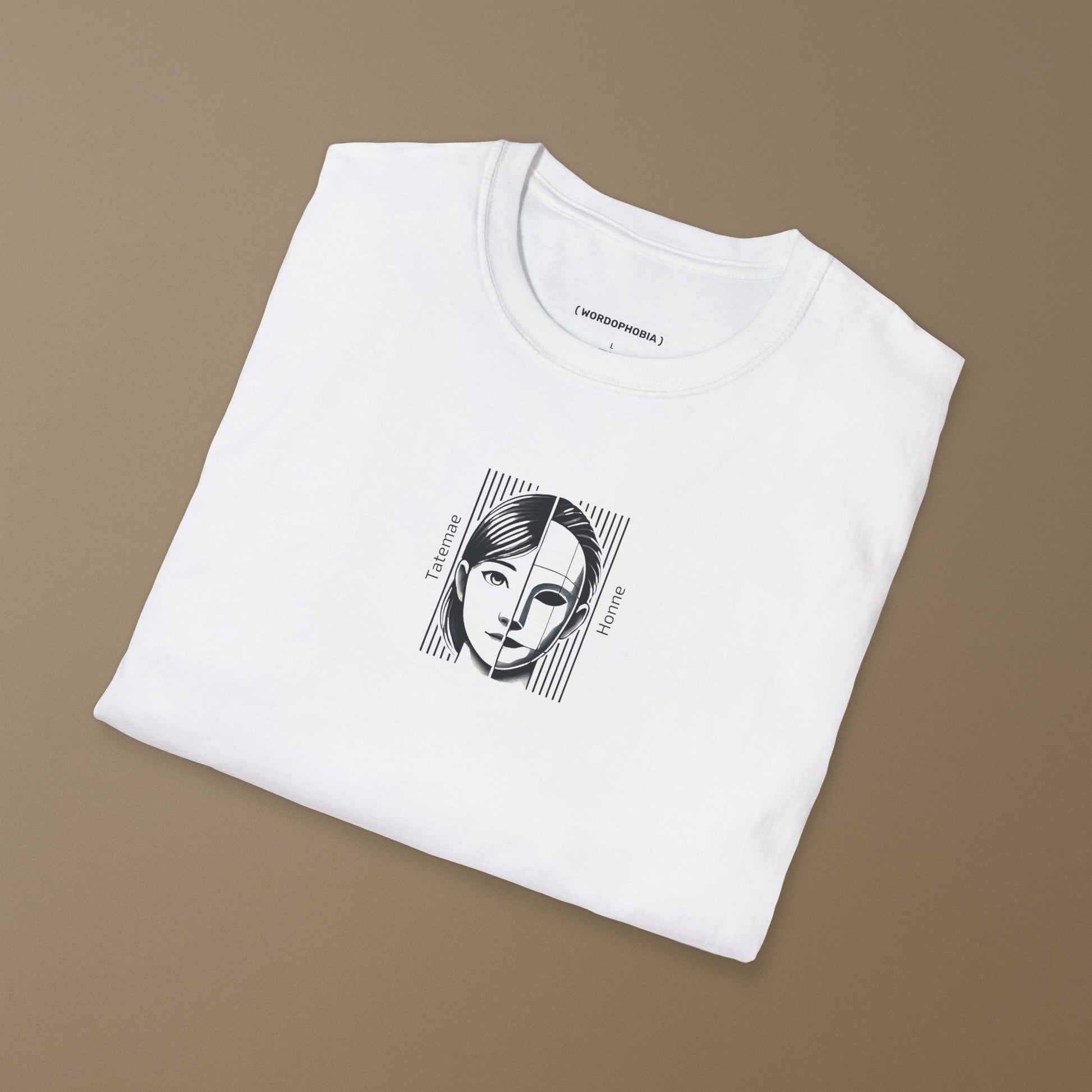 Folded white t-shirt with a graphic design of a face with 'Tatemae' and 'Honne' text on a brown background
